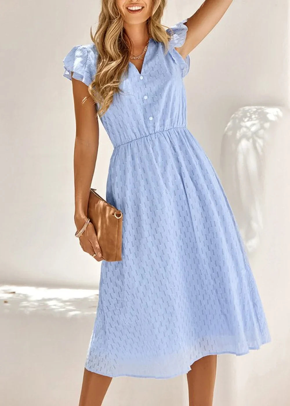 Light blue cotton midi dress with textured pattern, V-neck, and flutter sleeves on a model.