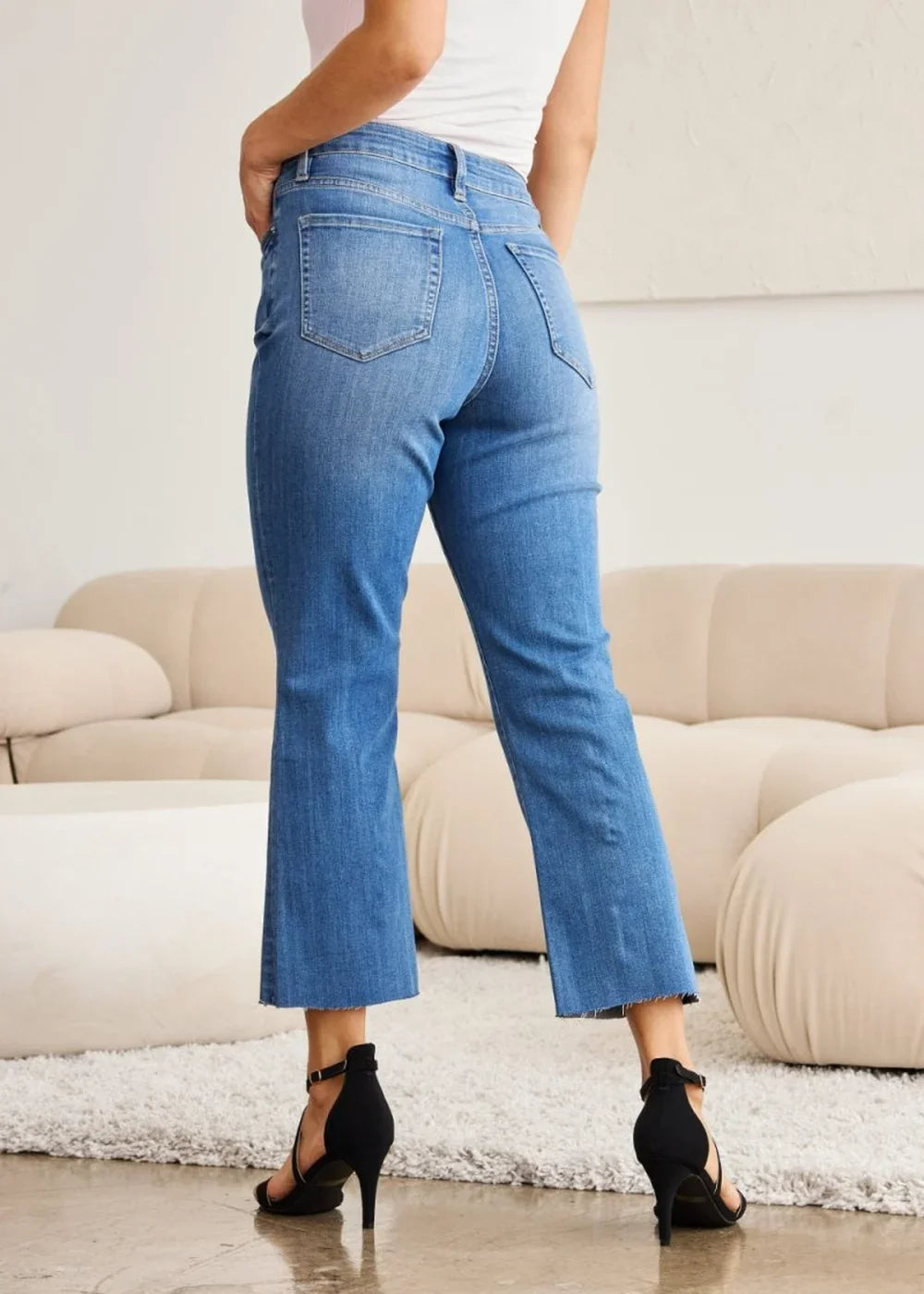 in a medium wash denim, showing the fit and fabric blend.