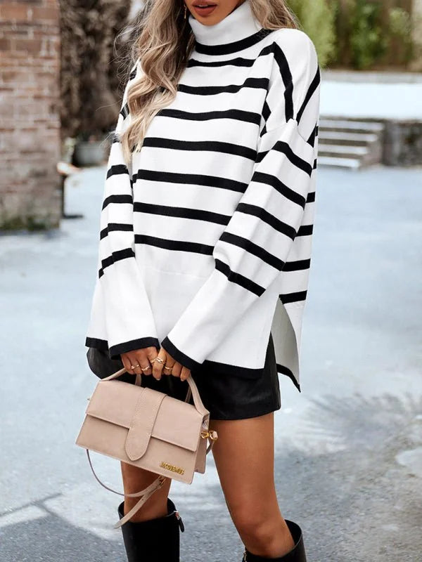 White and black striped turtleneck sweater with side slits and flared sleeves, worn by a model.