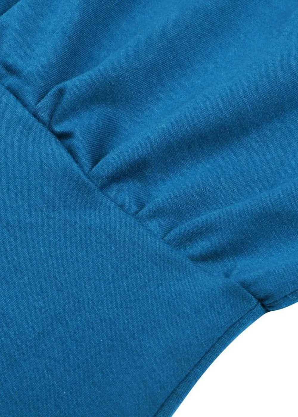 Close-up of a teal blue dress showing soft fabric texture and subtle pleating detail at the neckline.