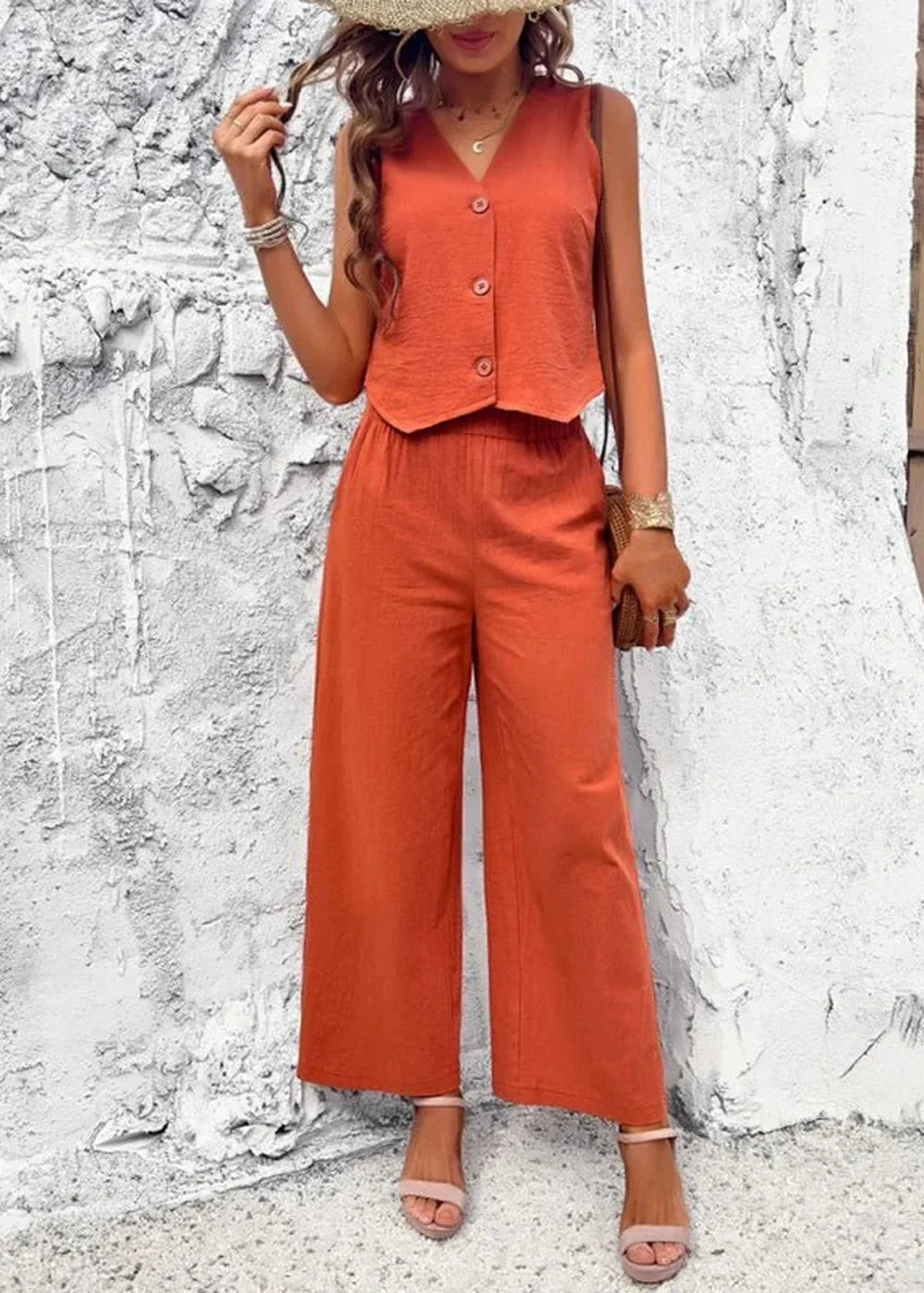 Orange cotton wide-leg pant suit with V-neck sleeveless top, on model.