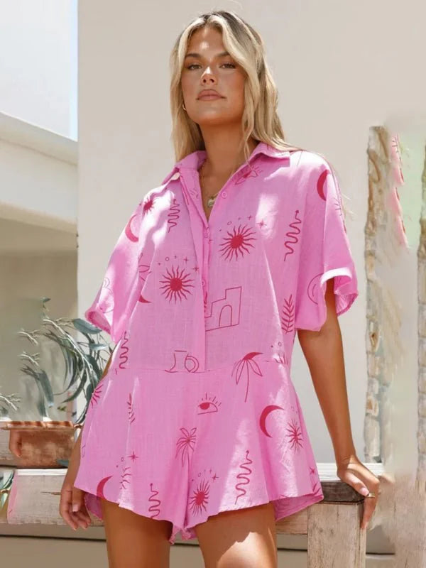 Pink short jumpsuit with celestial print, short sleeves, and collar on a model.