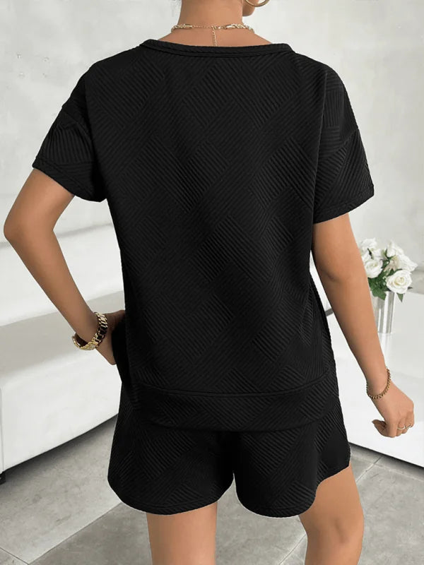 Black textured short suit with diagonal pattern, showing back view on model.