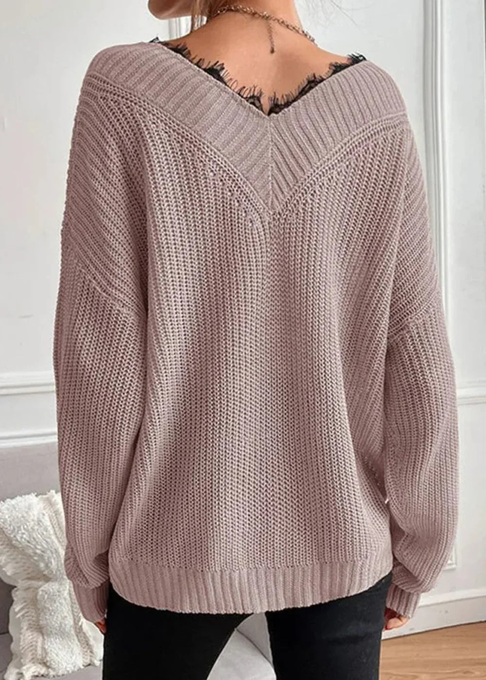 Back view of a dusty rose knit sweater with a V-neckline trimmed in black lace.