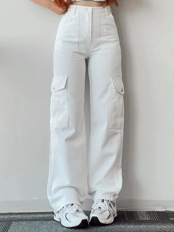 Relaxed fit white cargo pants with large side pockets and elastic cuffs, shown on model with sneakers.