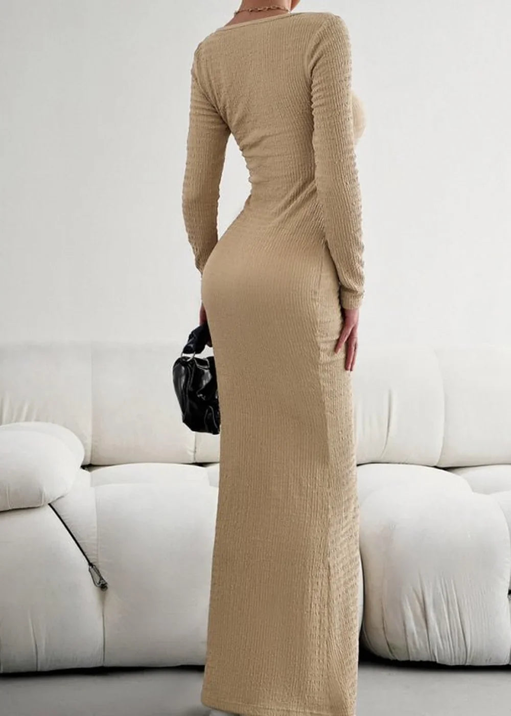 Back view of a fitted, long-sleeved, beige textured maxi dress with a ruched purse.