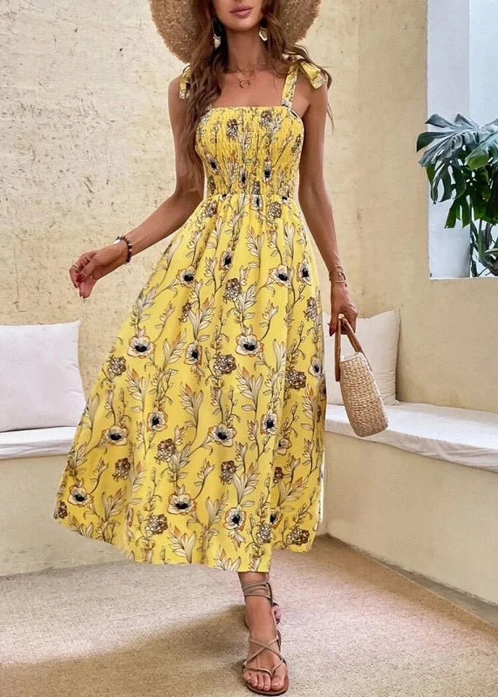 Yellow floral print midi dress with smocked bodice and tie straps.