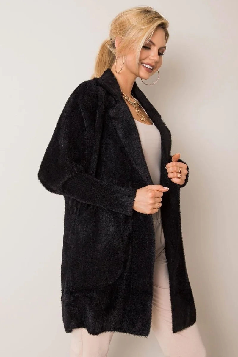 A plush black angora blend cardigan with a relaxed fit and open front, worn by a smiling blonde model.