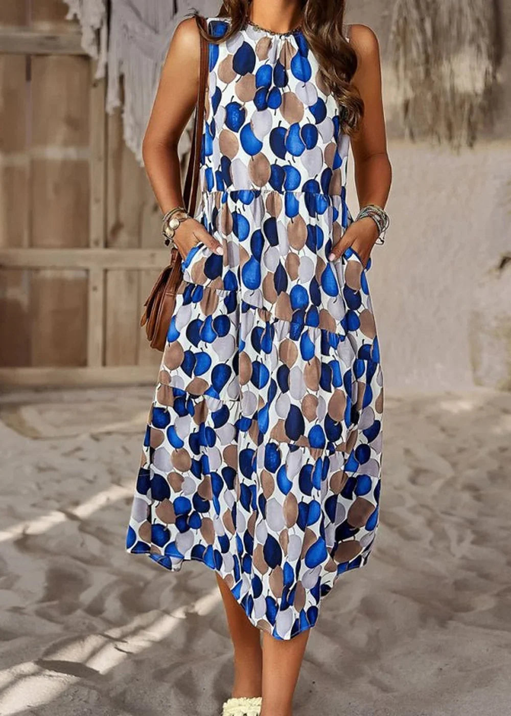 Blue, brown, and grey leaf print tiered midi dress with pockets.
