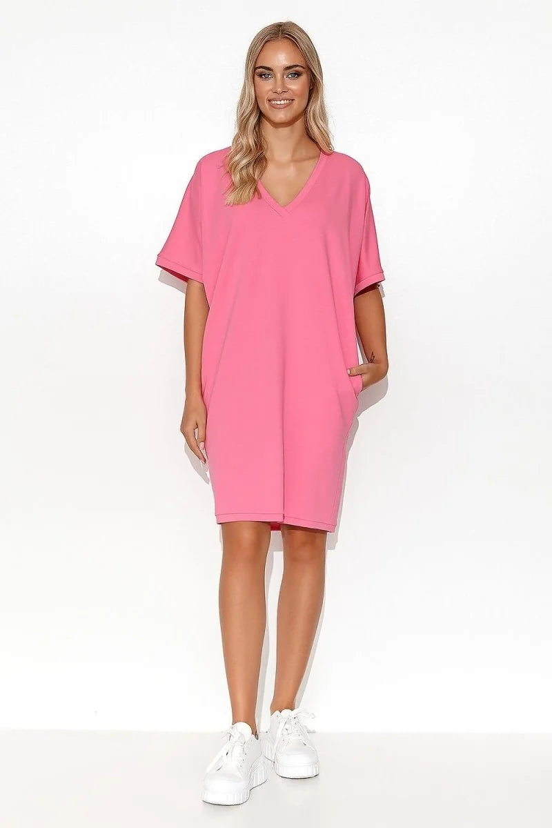 Hot pink cotton-blend v-neck t-shirt dress with pockets, on a model.