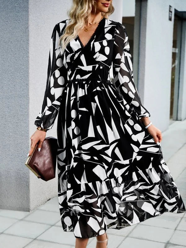 Black and white abstract print chiffon midi dress with V-neck and long sleeves, shown on model.
