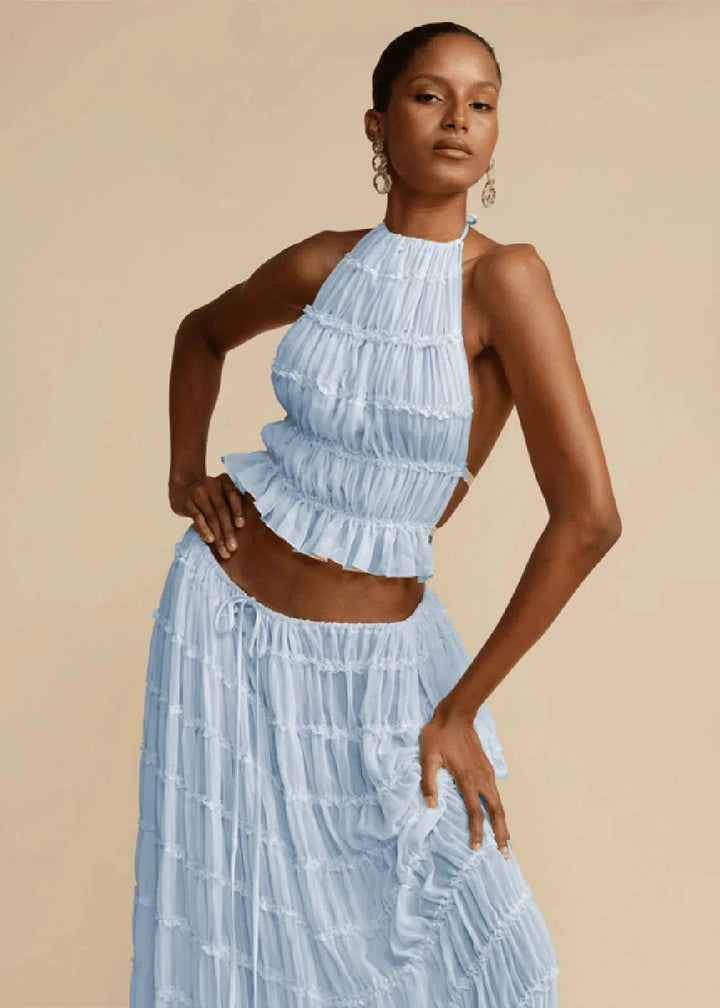 Light blue ruffled halter crop top and tiered maxi skirt suit, made of polyester.