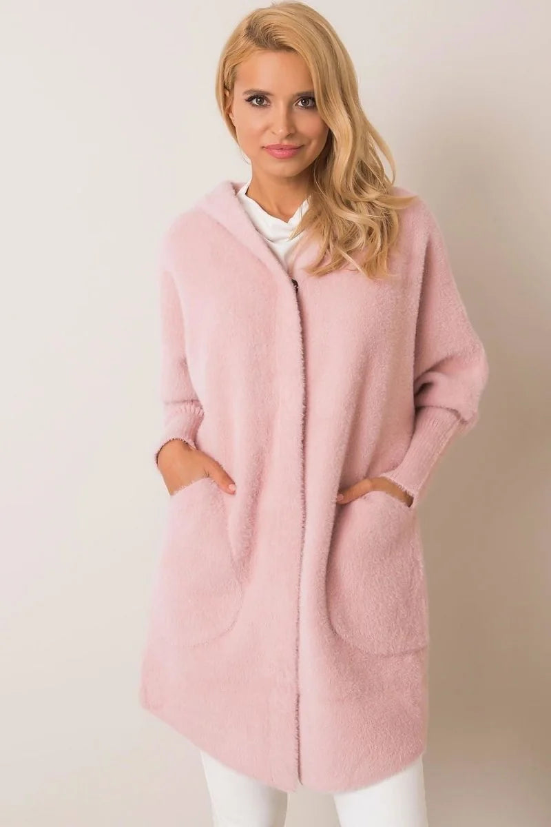 A light pink fuzzy cardigan with pockets and a hood, worn by a blonde model.