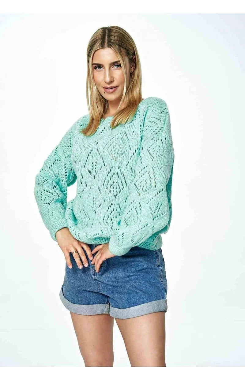 Mint green open-knit sweater with relaxed fit and cuffed denim shorts on model