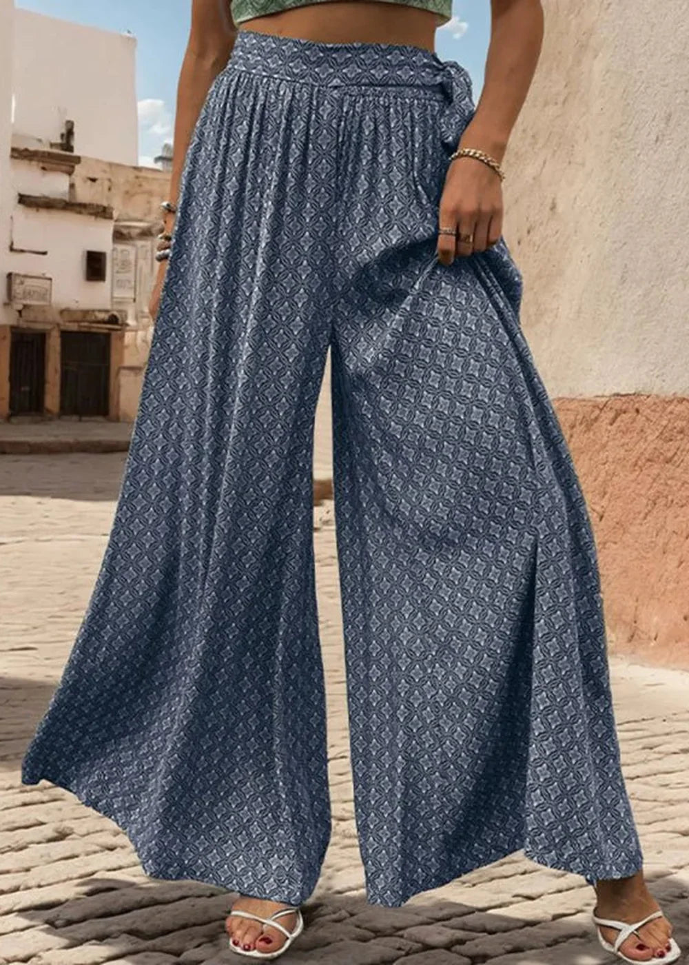 Navy blue wide-leg palazzo pants with a geometric diamond print and a tie waist.