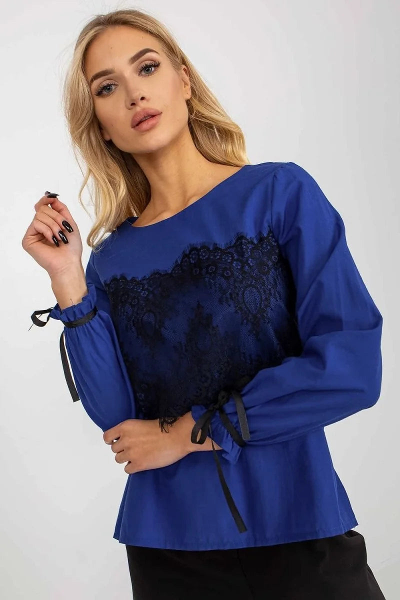 Royal blue long-sleeve top with black lace inset and tie details on sleeves.