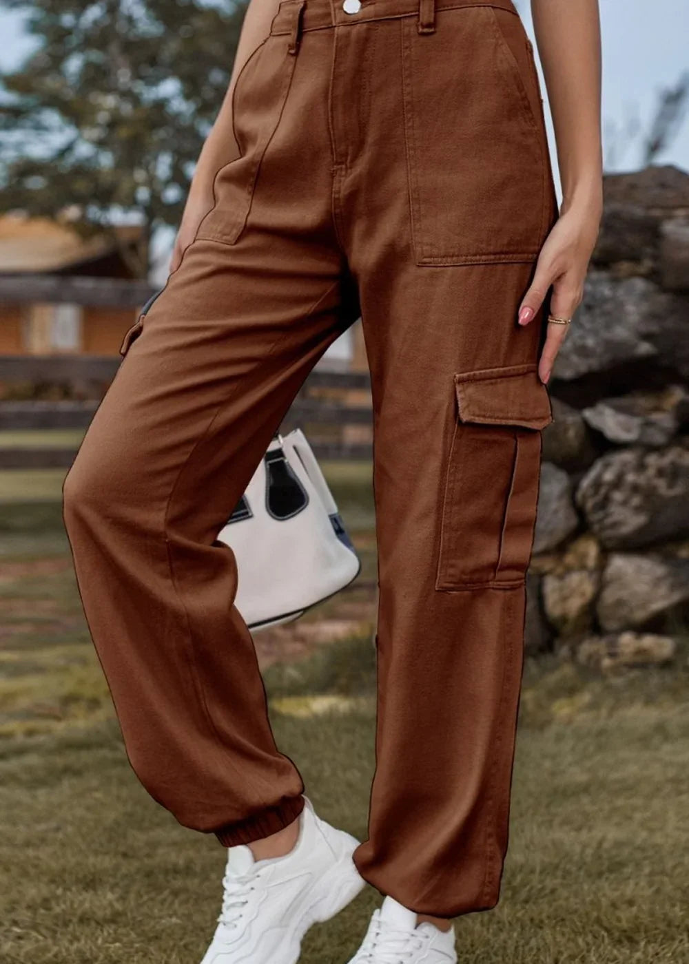 Brown cargo pants with elastic cuffs and pocket details, worn with white sneakers.