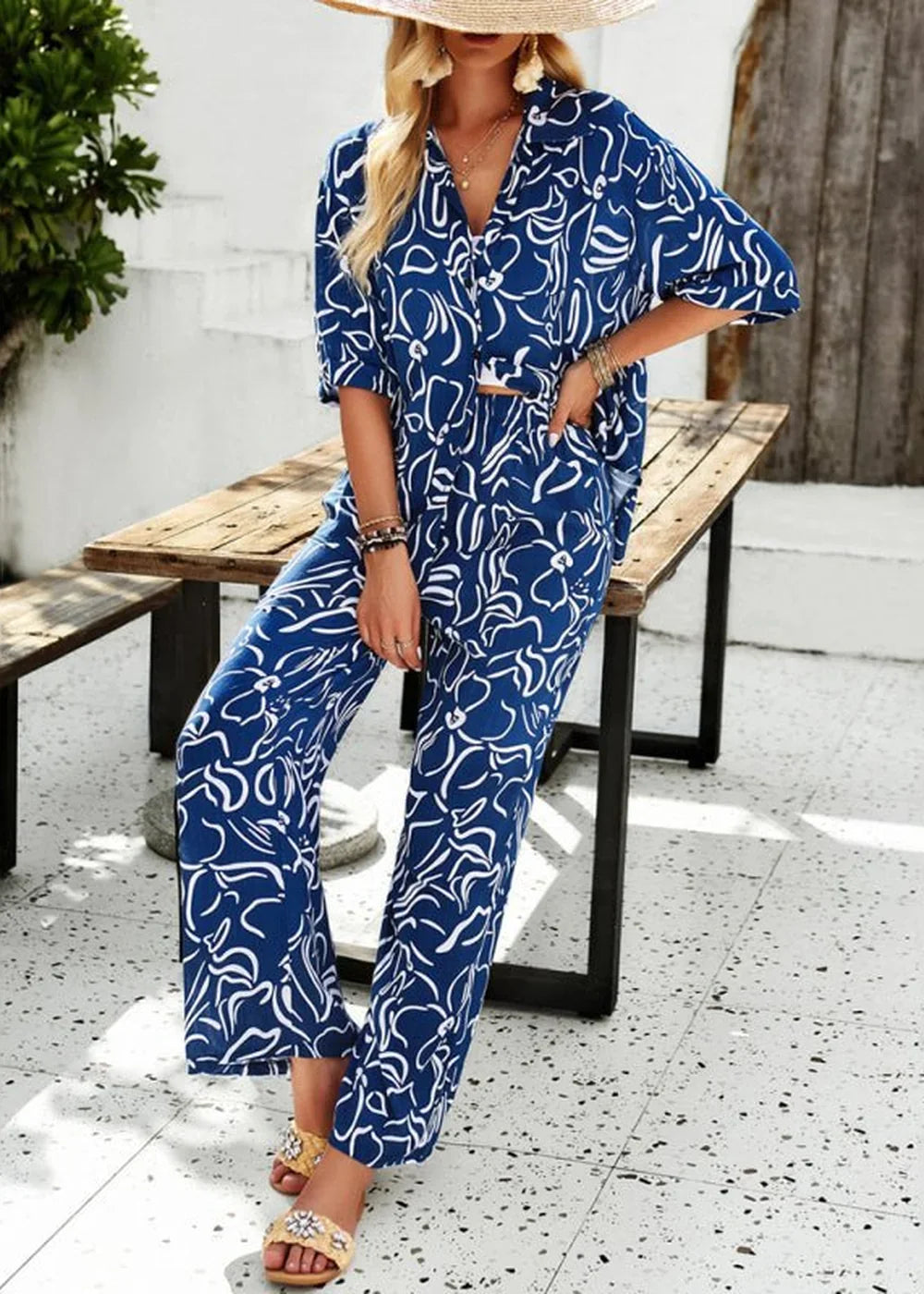 Navy blue and white floral print wide-leg pant suit with a v-neck top.