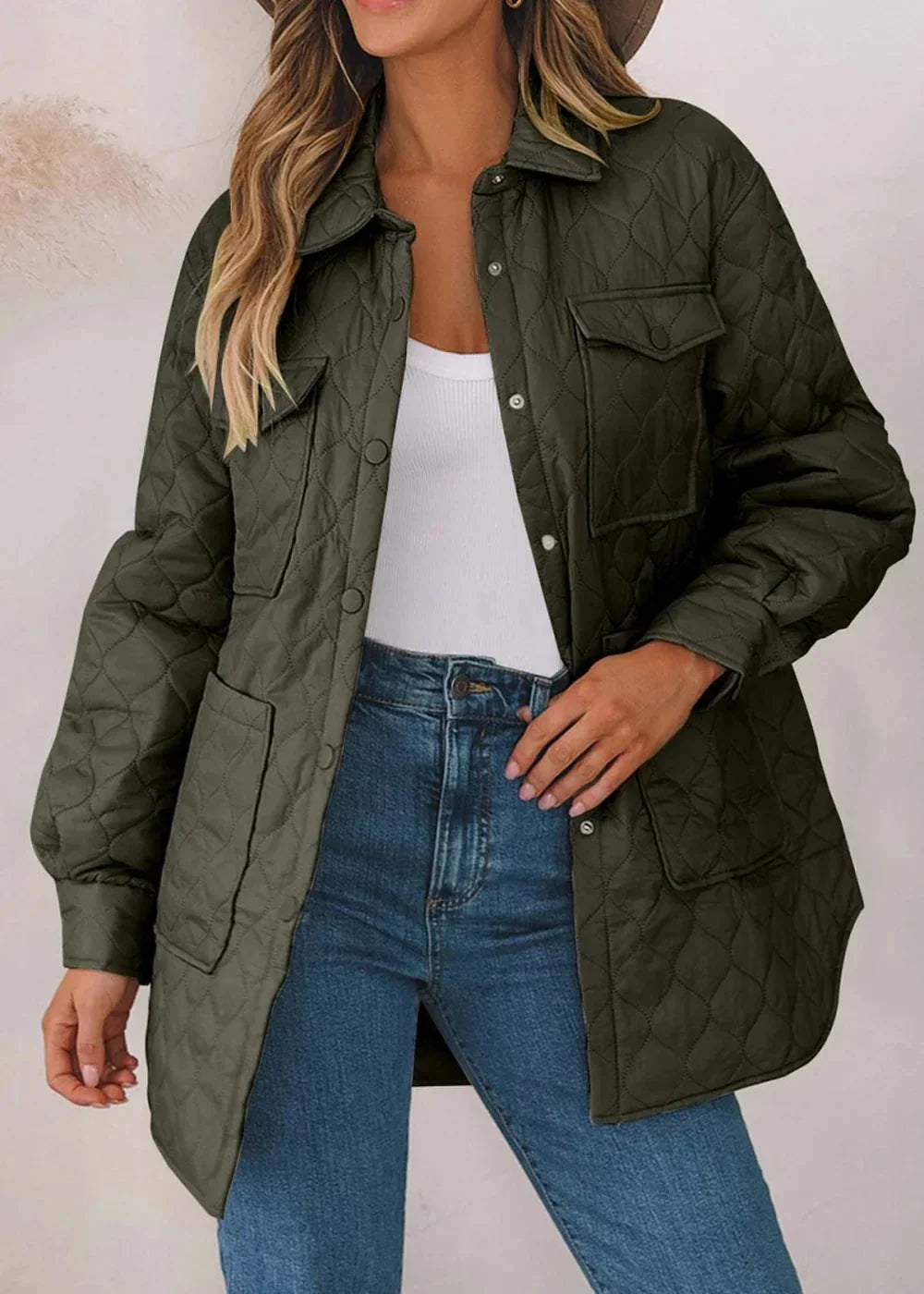 Quilted olive green jacket with button front and chest pockets, worn with a white tank and jeans.