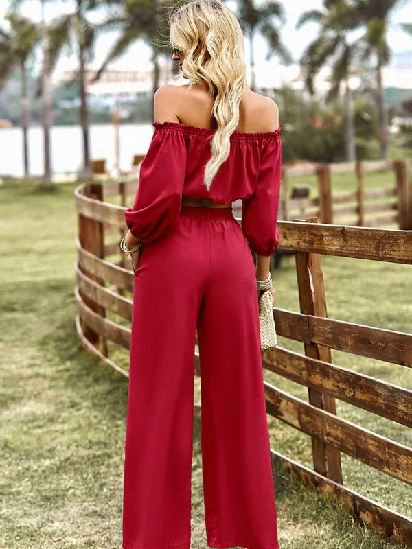 Red off-the-shoulder crop top with wide-leg pants, shown from the back.