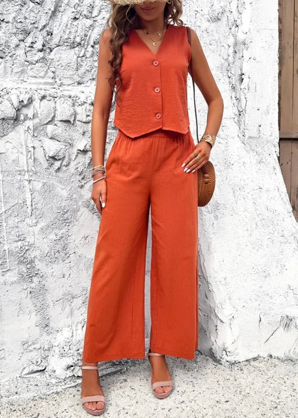 Orange cotton two-piece set with a v-neck vest and wide-leg pants, worn by a model.