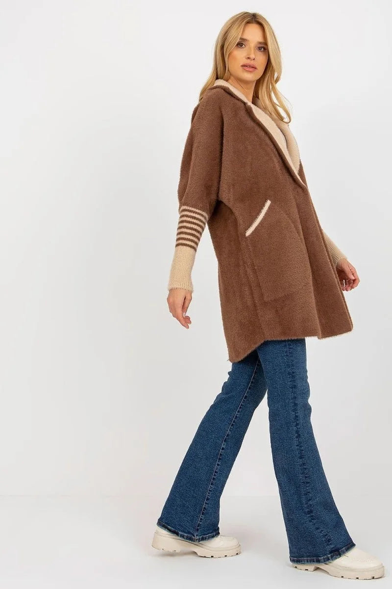 Brown fuzzy open-front cardigan with cream trim and striped cuffs on model.