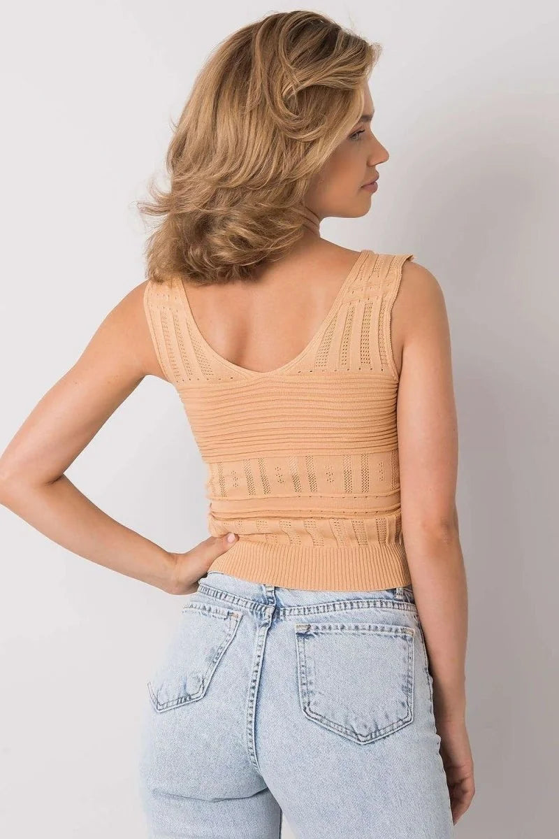 Light peach knit tank top with textured stripes and eyelet details, shown on a model wearing light wash jeans.