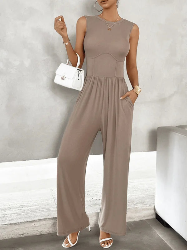 Taupe sleeveless jumpsuit with a corset-style bodice and wide legs, worn by a model.