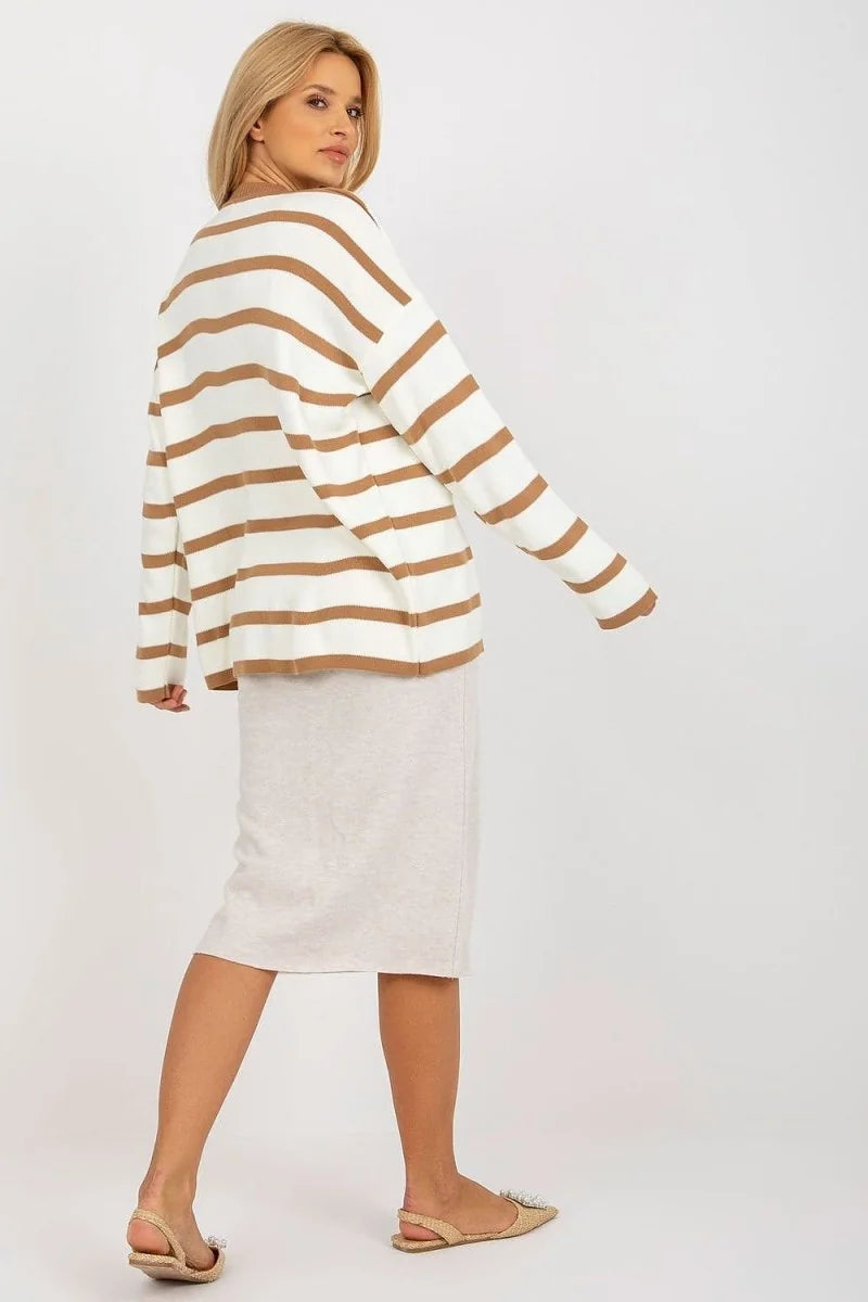 Relaxed fit cream sweater with horizontal brown stripes, worn with a light beige pencil skirt.