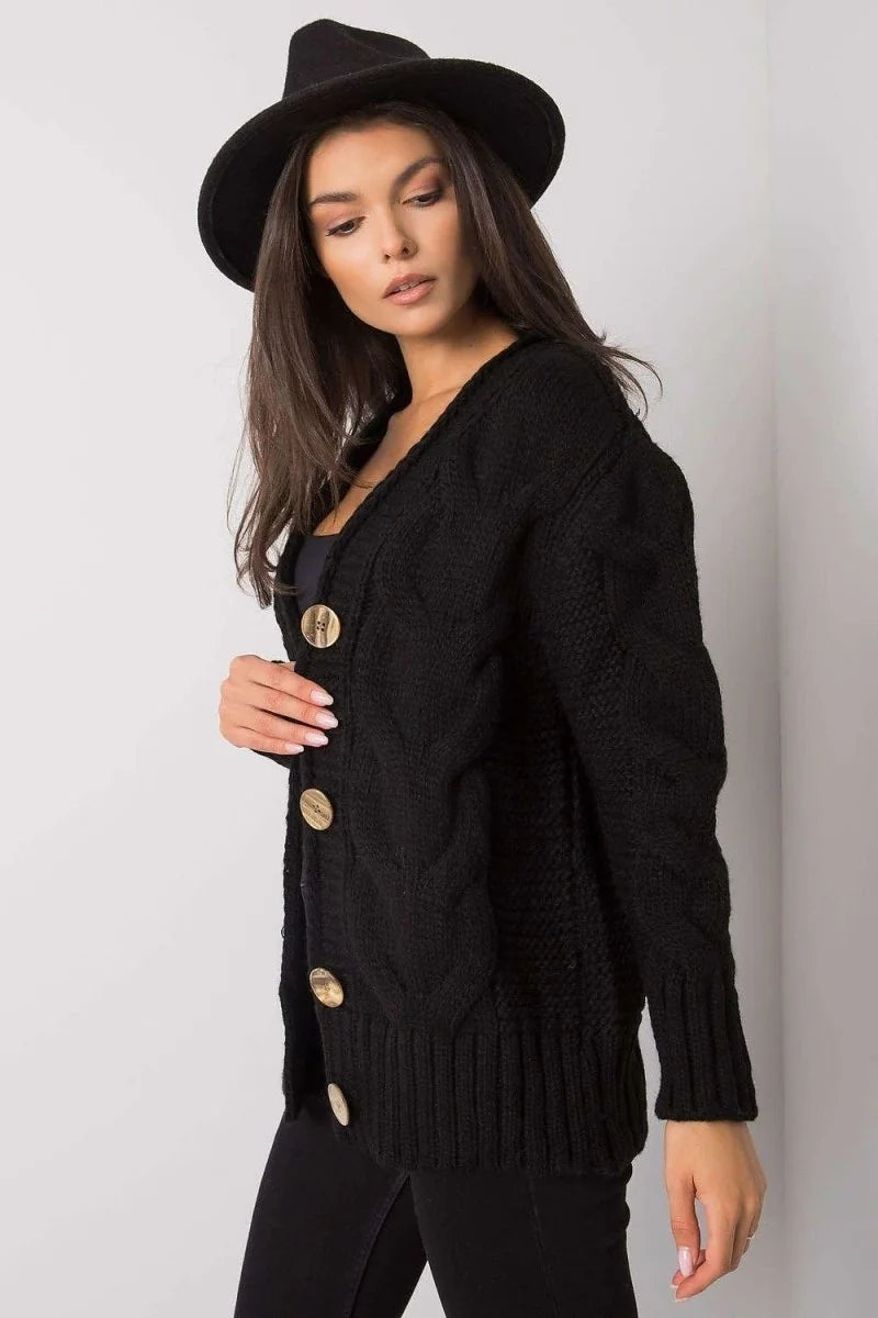 Black knit cardigan with wooden buttons and textured weave, on a model.