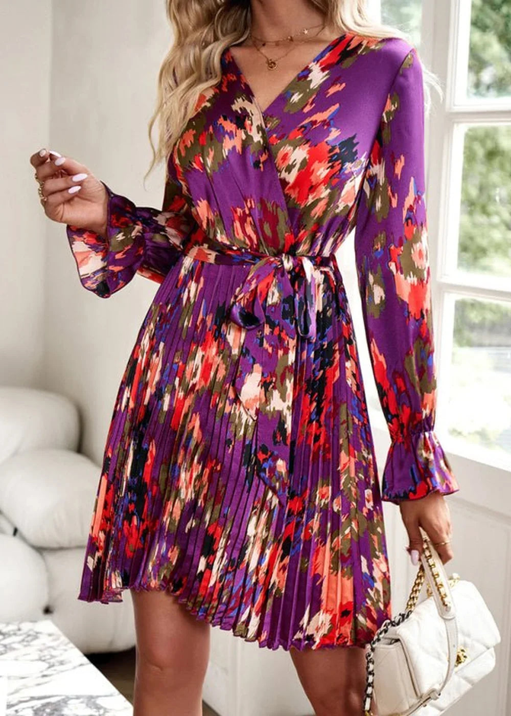 Purple floral print dress with a V-neck, tie waist, and pleated skirt.