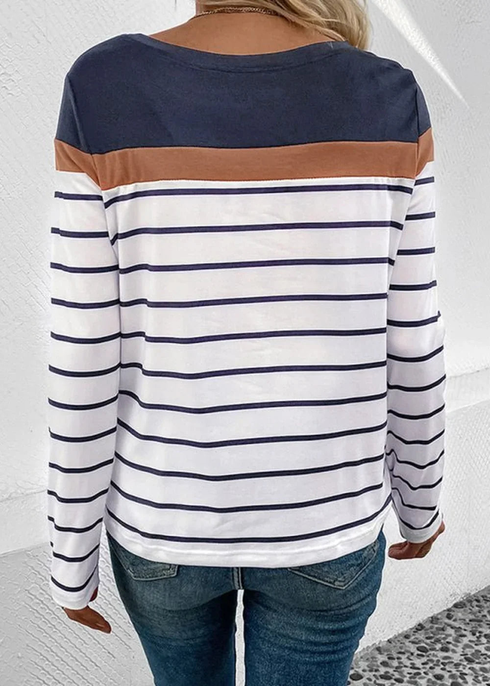 Back view of a striped long-sleeve shirt with navy blue and tan accents.