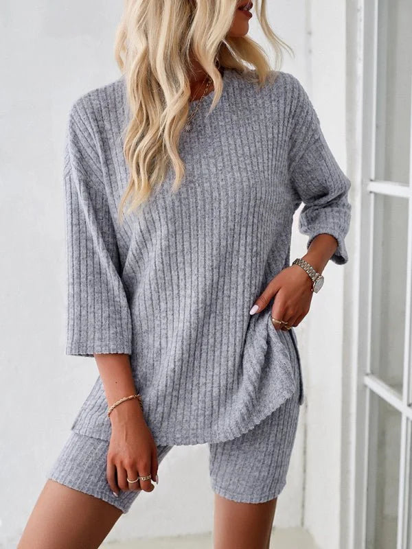Gray ribbed knit short suit with a relaxed fit, featuring a 3/4 sleeve top and matching biker shorts.