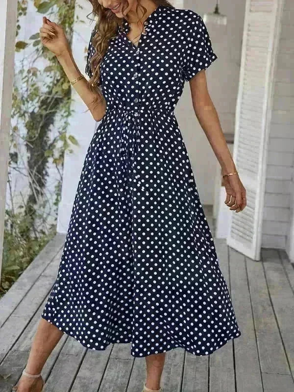Navy blue rayon dress with white polka dots, short sleeves, and tie waist.
