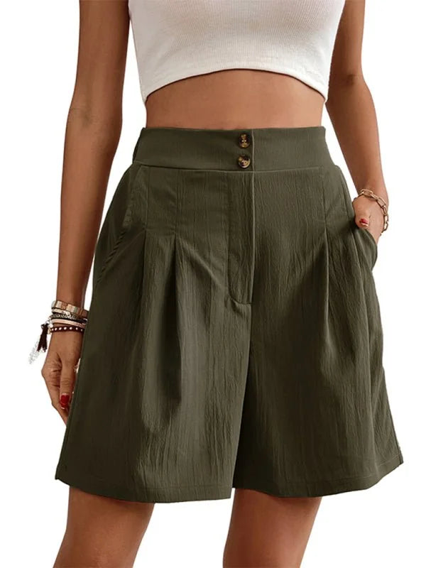 Olive green textured shorts with two-button closure and pleats, shown on a model.