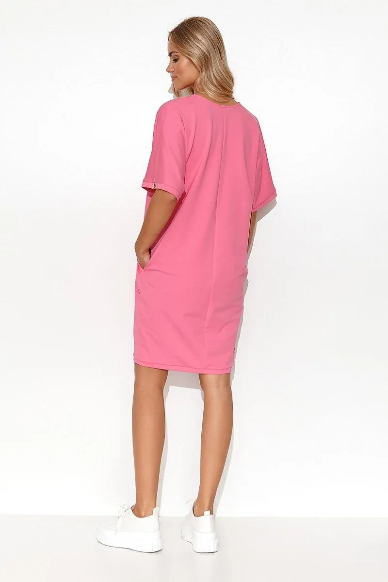 Pink cotton-spandex short-sleeve t-shirt dress with pockets and white sneakers.