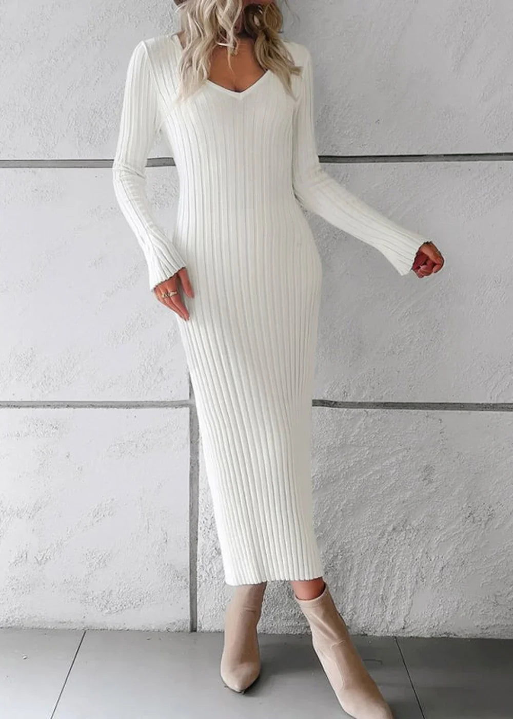 Cream ribbed knit midi sweater dress with long sleeves and a v-neck, worn by a model with tan boots.