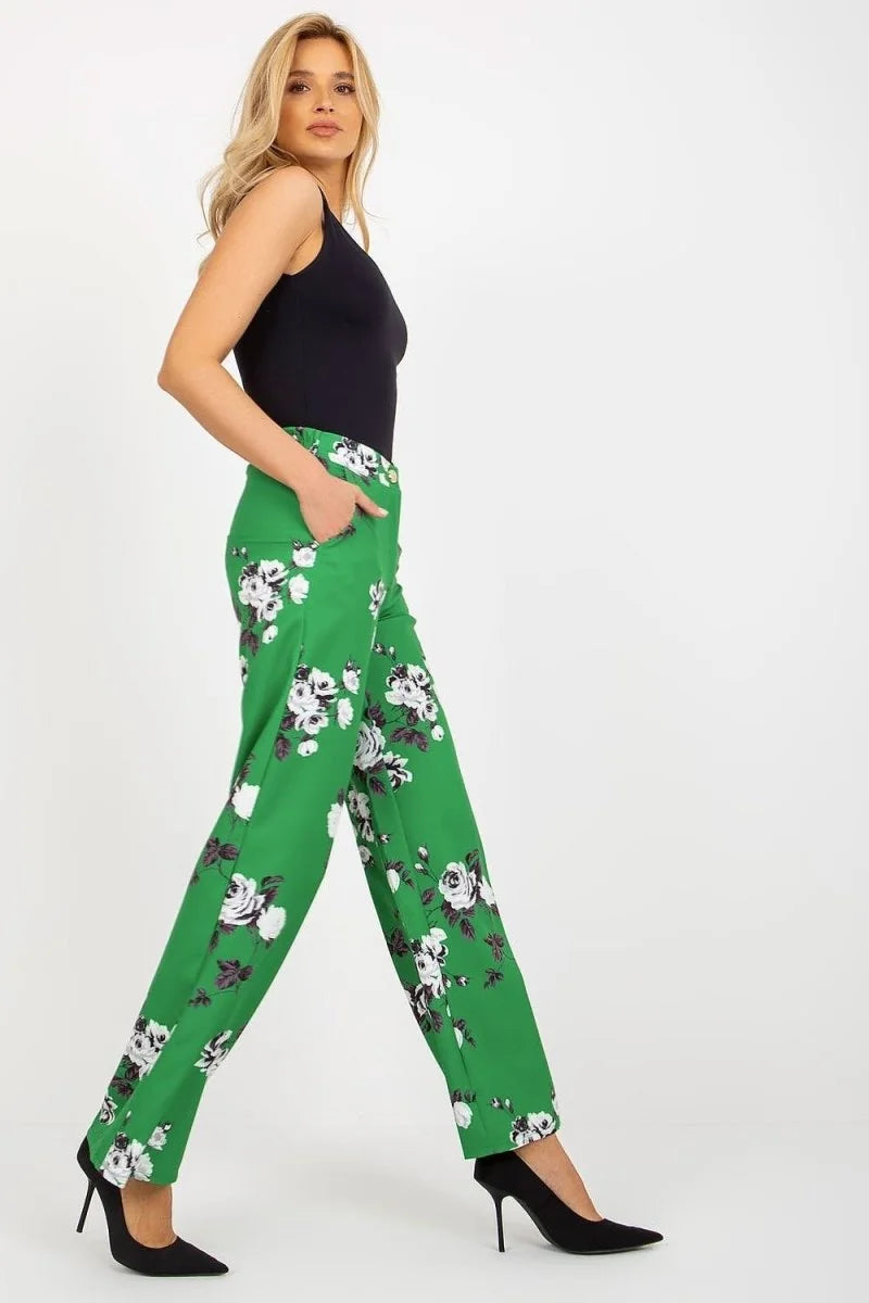 Green pants with a white floral pattern, regular fit, on a model.