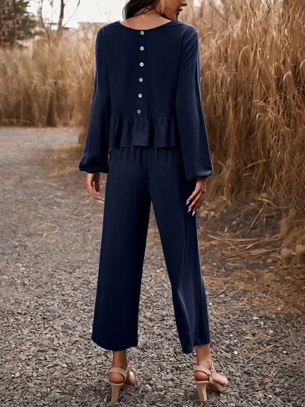 Navy blue linen-blend two-piece set with ruffled peplum top and wide-leg pants shown from the back.