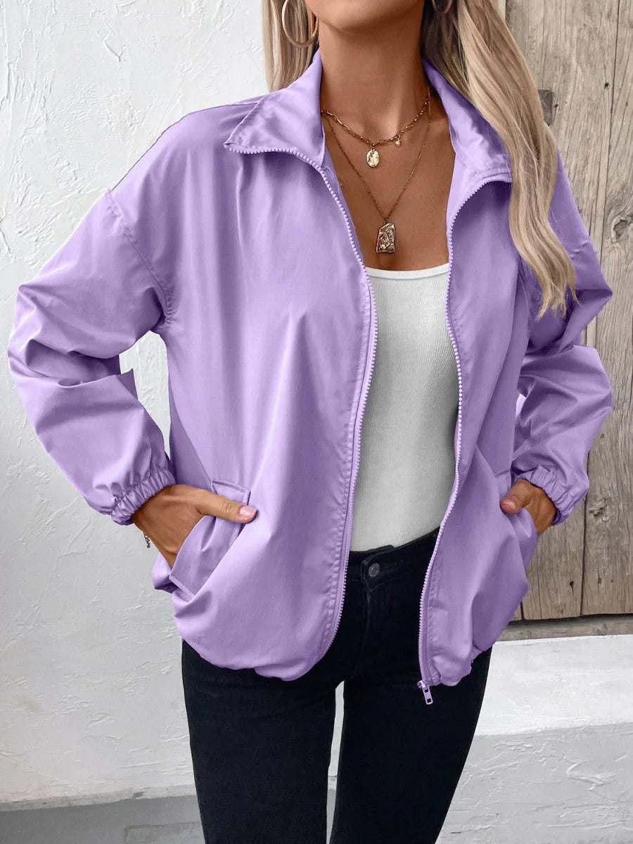 Lavender lightweight jacket with a zip-up front and pockets on model.