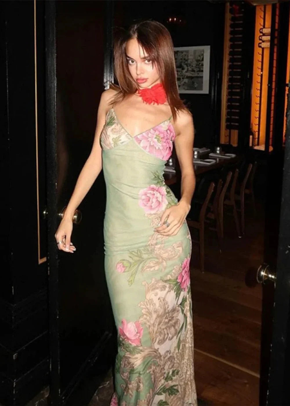 Green floral print slip dress with pink flowers and a red choker on a model.