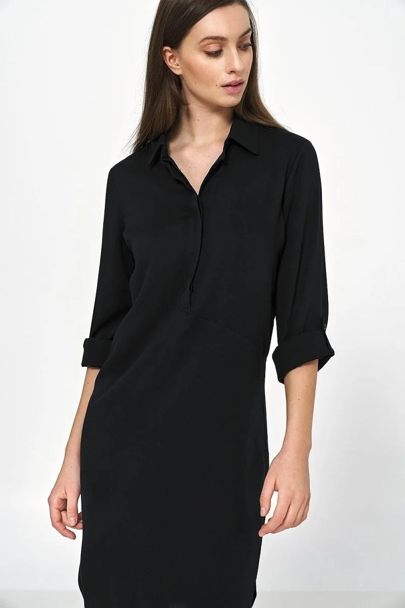 Black oversized viscose shirt dress with rolled-up sleeves and a collar, shown on a model.