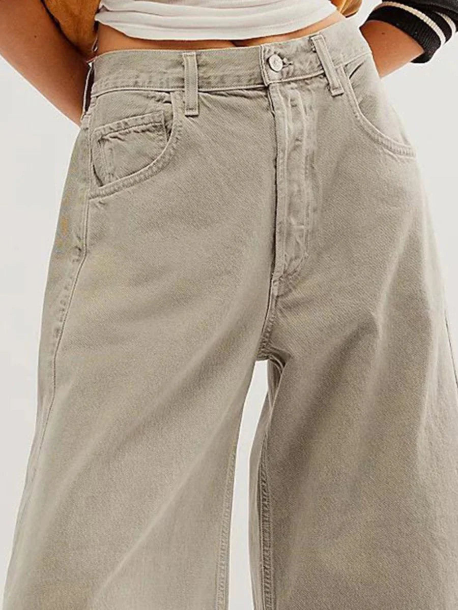 High-waisted, wide-leg pants in a muted taupe color, made of a soft, slightly textured fabric.