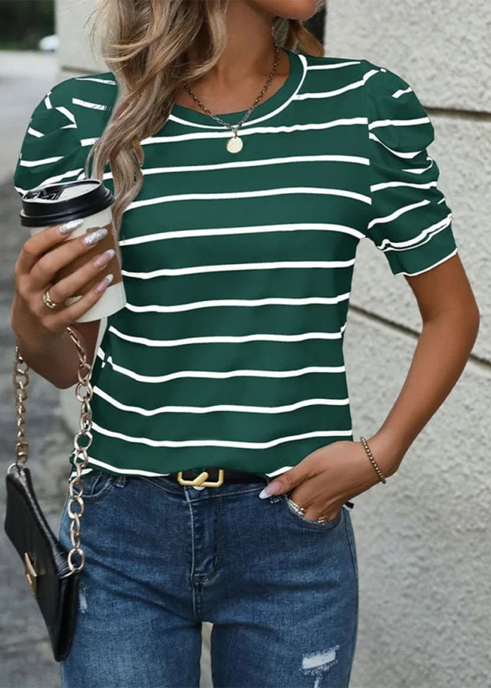 Green and white striped puff-sleeve top with a necklace and jeans on a model.