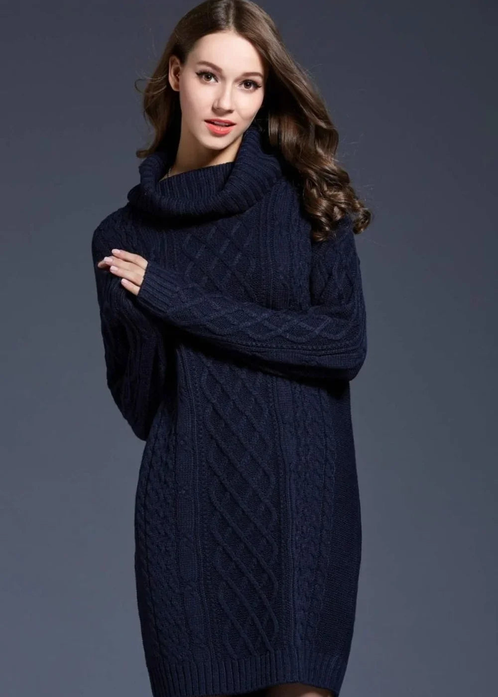 Navy blue cable-knit turtleneck sweater dress with long sleeves on a model.