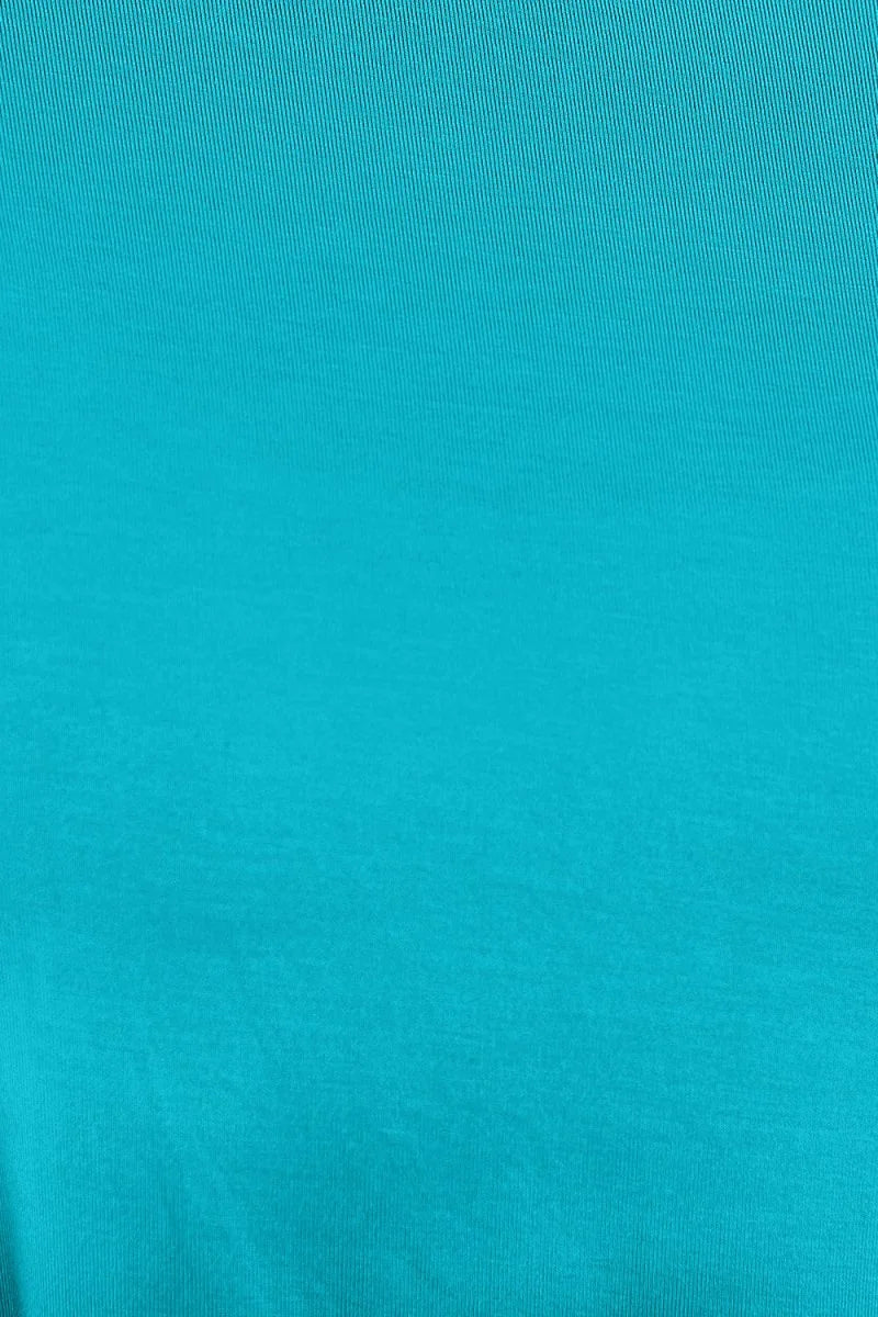 Close-up of a textured, bright teal rayon and spandex fabric.