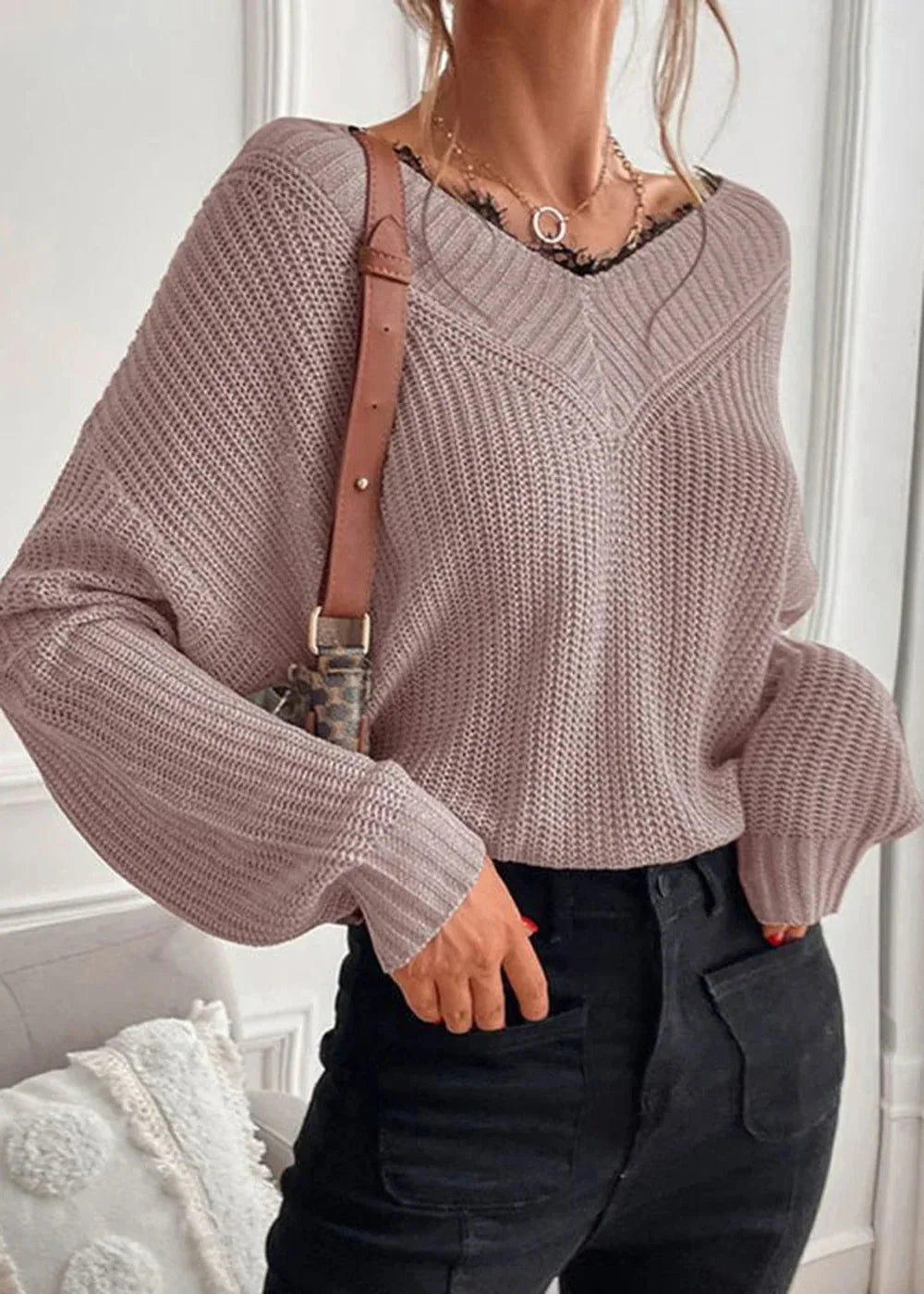 Light pink V-neck knit sweater with lace trim and balloon sleeves, worn by a model.