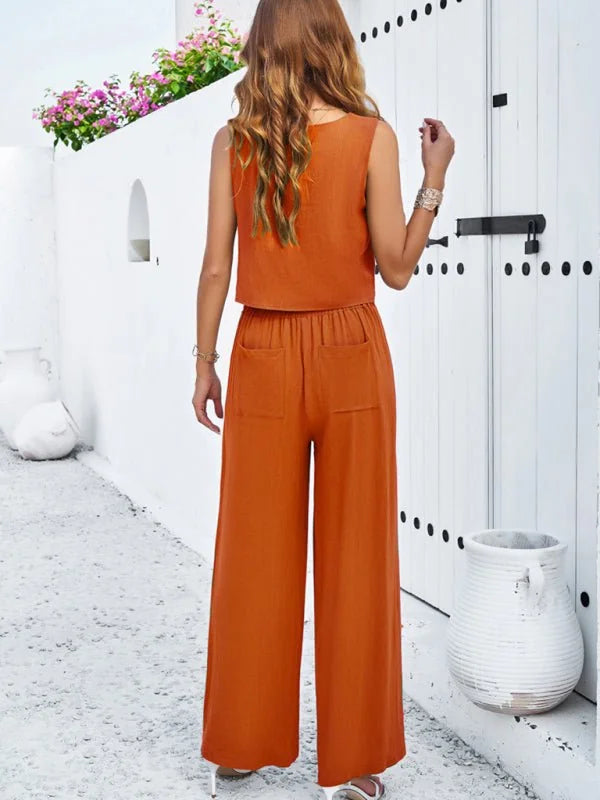 Orange wide-leg pant suit with a cropped sleeveless top, featuring patch pockets and a textured viscose fiber.