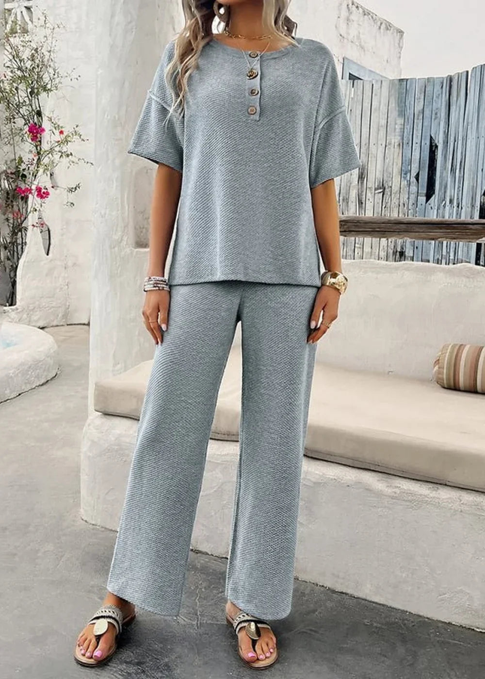 Light blue ribbed knit two-piece set with short sleeves and wide-leg pants, on model.