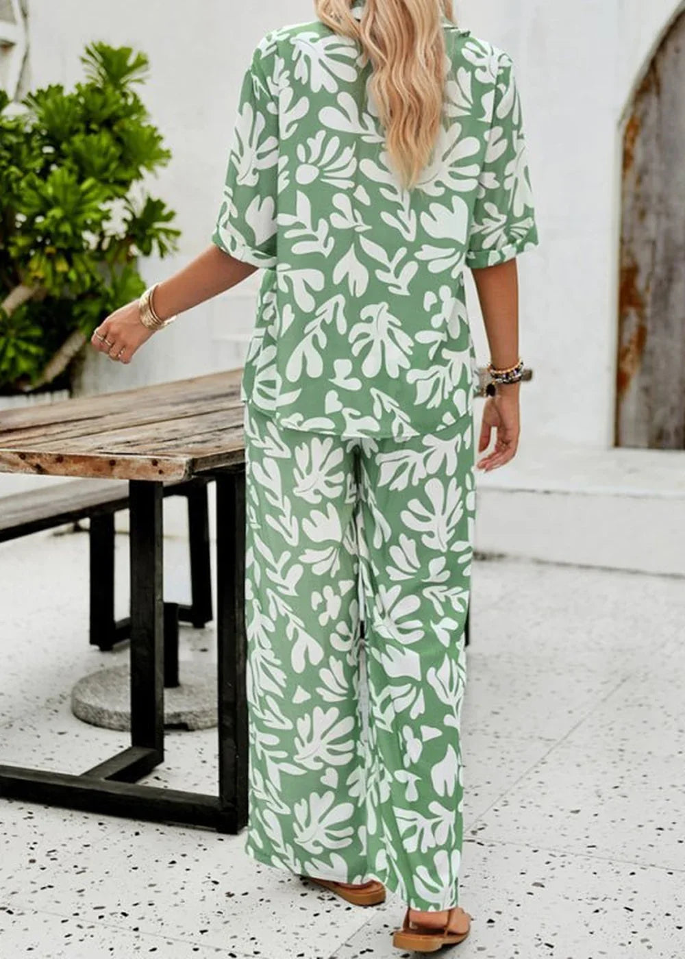 Green and white leaf print viscose wide-leg pant suit with bracelets.